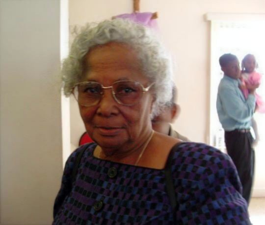 Portrait of Grandmother Daisy, a warm and dignified woman with silver hair and glasses whose legacy of love inspires the foundation